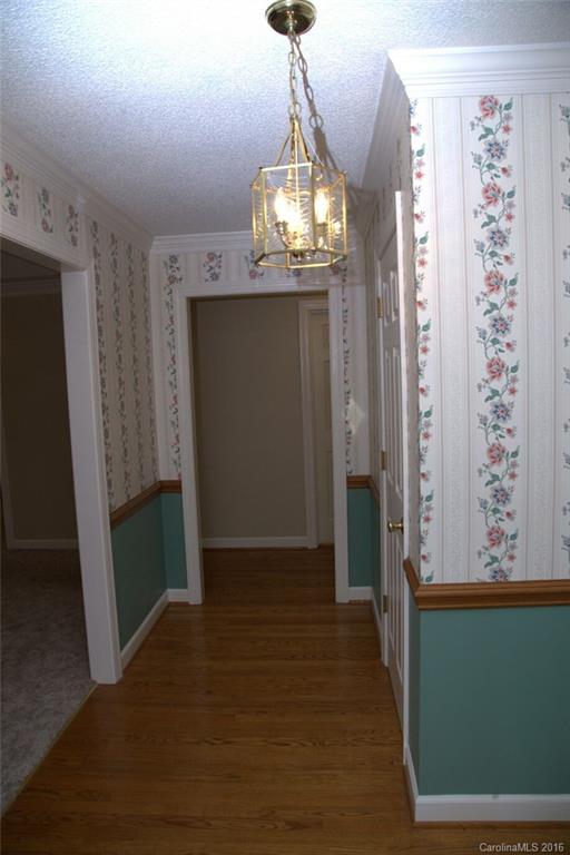 2710 Blue Jay Road Heath Springs, SC 29058 - Photo 10 of 21 a view of a hallway with wooden floor and staircase