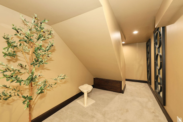 3104 East High Danish Road Sandy, UT 84093 - Photo 29 of 36 Recessed lighting illuminates a carpeted hallway with dark baseboards and warm-toned walls