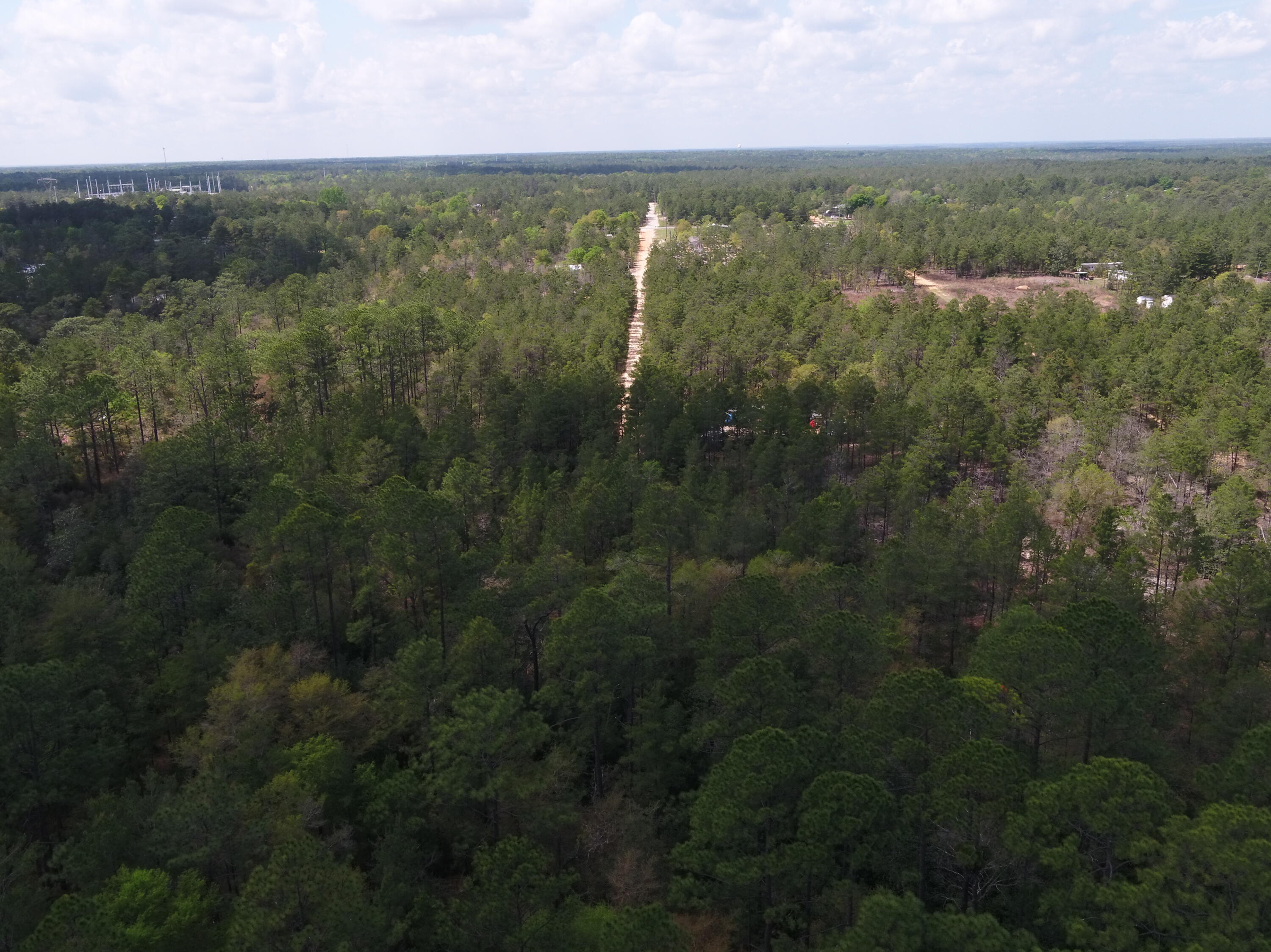 0 East Snapdragon Street DeFuniak Springs, FL 32433 - Photo 22 of 24 an aerial view of residential houses with outdoor space and trees