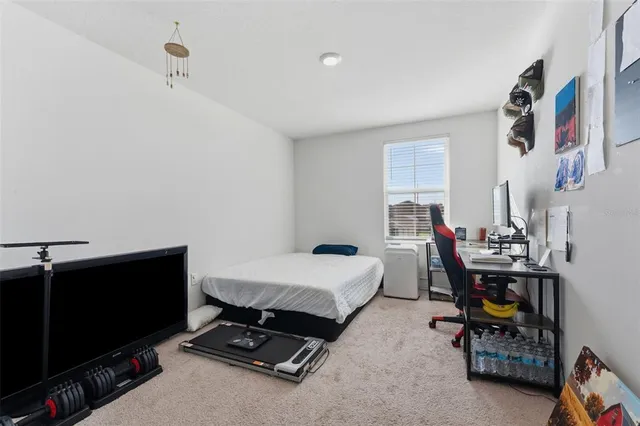 a bedroom with furniture and a flat screen tv