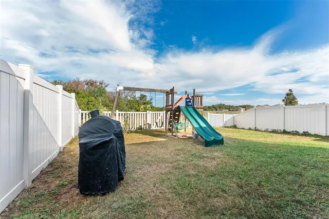 a view of a backyard with swimming pool
