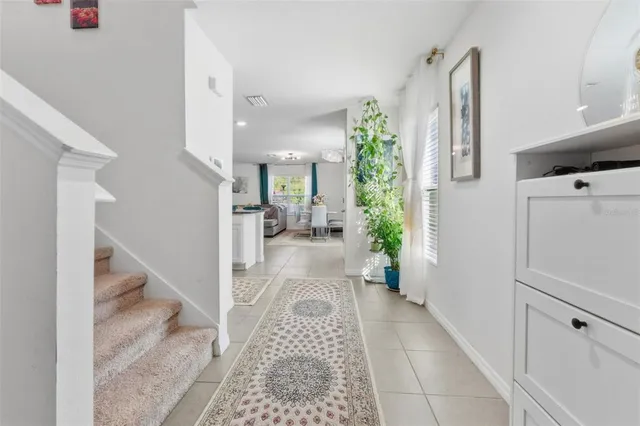 a view of a hallway to a livingroom with furniture and an entryway