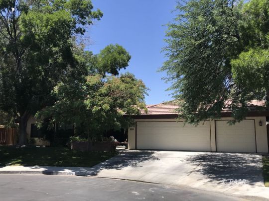 1009 Meadowview Lane Ridgecrest, CA 93555 - Photo 3 of 32 a house with trees in front of it