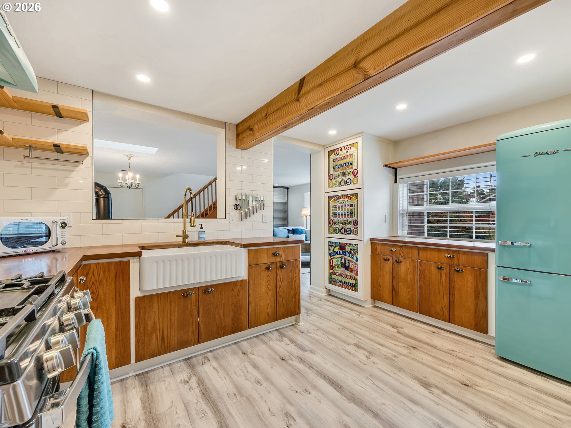 1761 South Edgewood Street Seaside, OR 97138 - Photo 11 of 48 a large kitchen with stainless steel appliances kitchen island granite countertop a sink and wooden cabinets