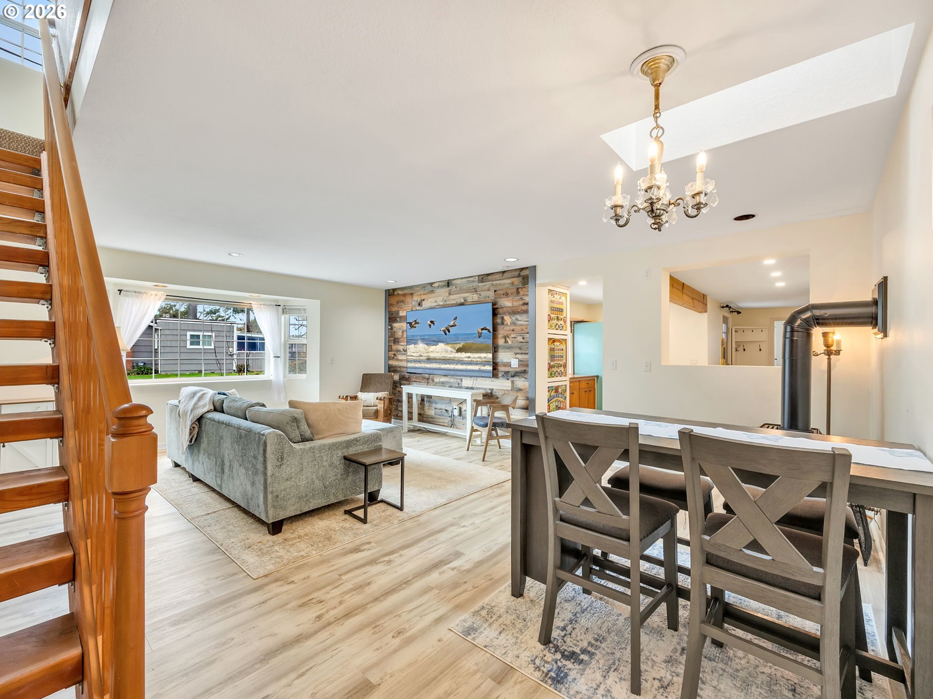 1761 South Edgewood Street Seaside, OR 97138 - Photo 18 of 48 a living room with furniture a flat screen tv and a floor to ceiling window