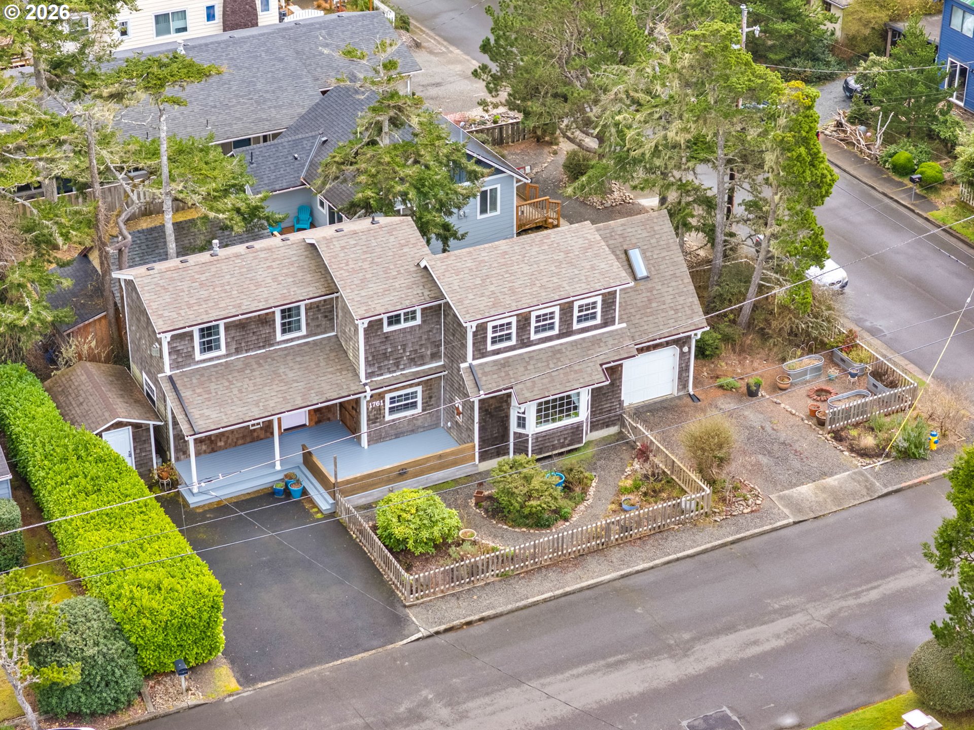 1761 South Edgewood Street Seaside, OR 97138 - Photo 2 of 48 an aerial view of multiple houses with a yard