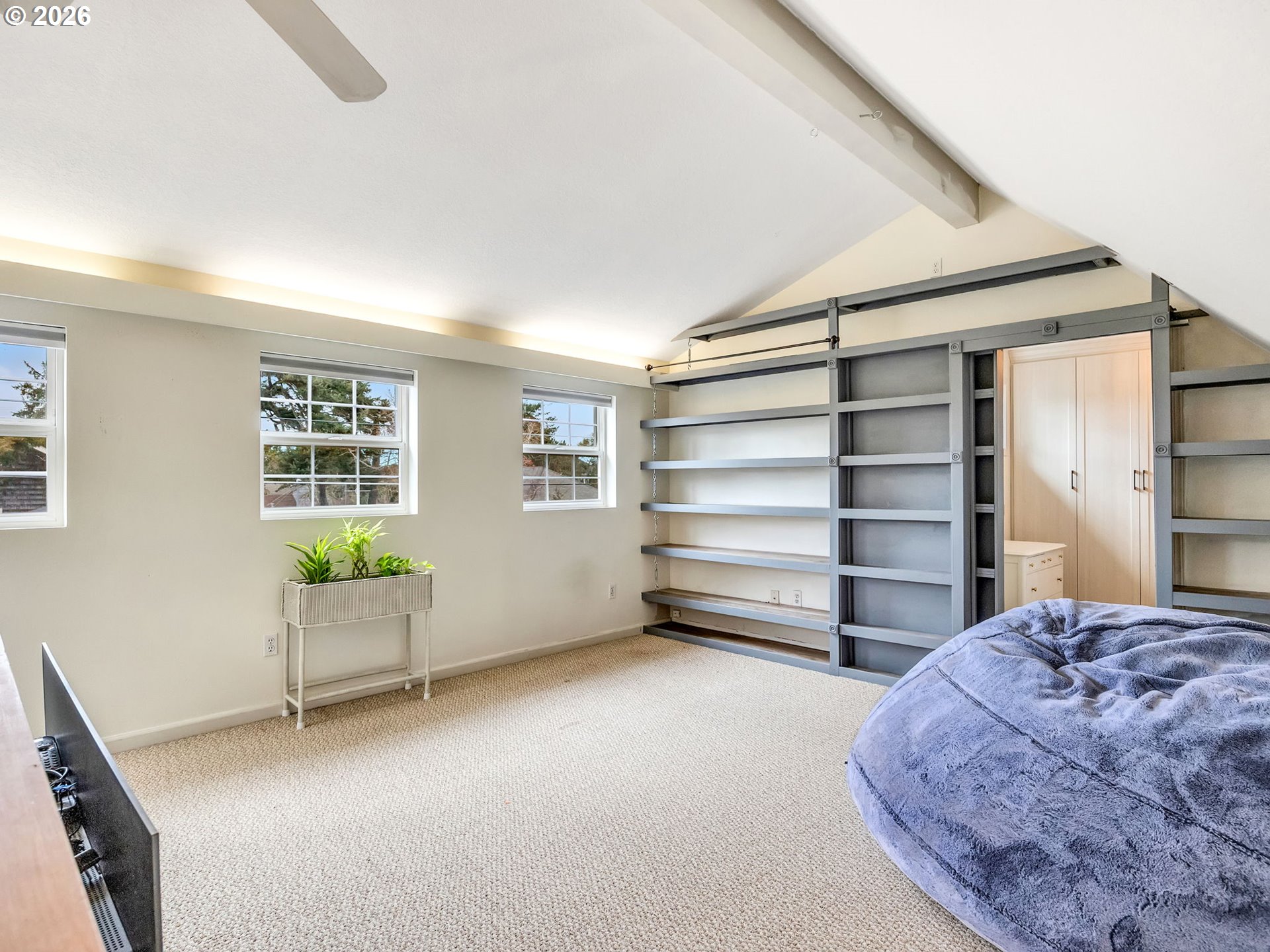1761 South Edgewood Street Seaside, OR 97138 - Photo 27 of 48 a bedroom with a bed and a chair
