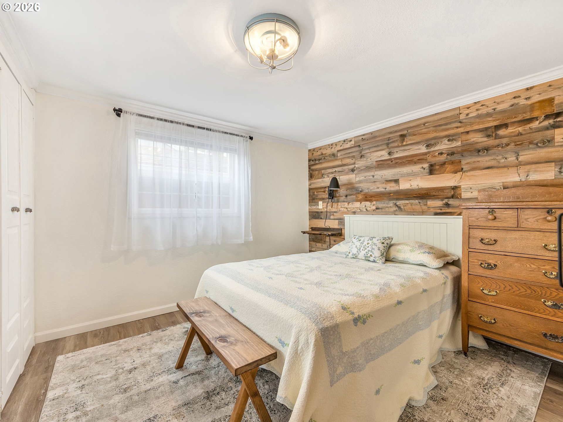 1761 South Edgewood Street Seaside, OR 97138 - Photo 7 of 48 a bedroom with a bed and a window