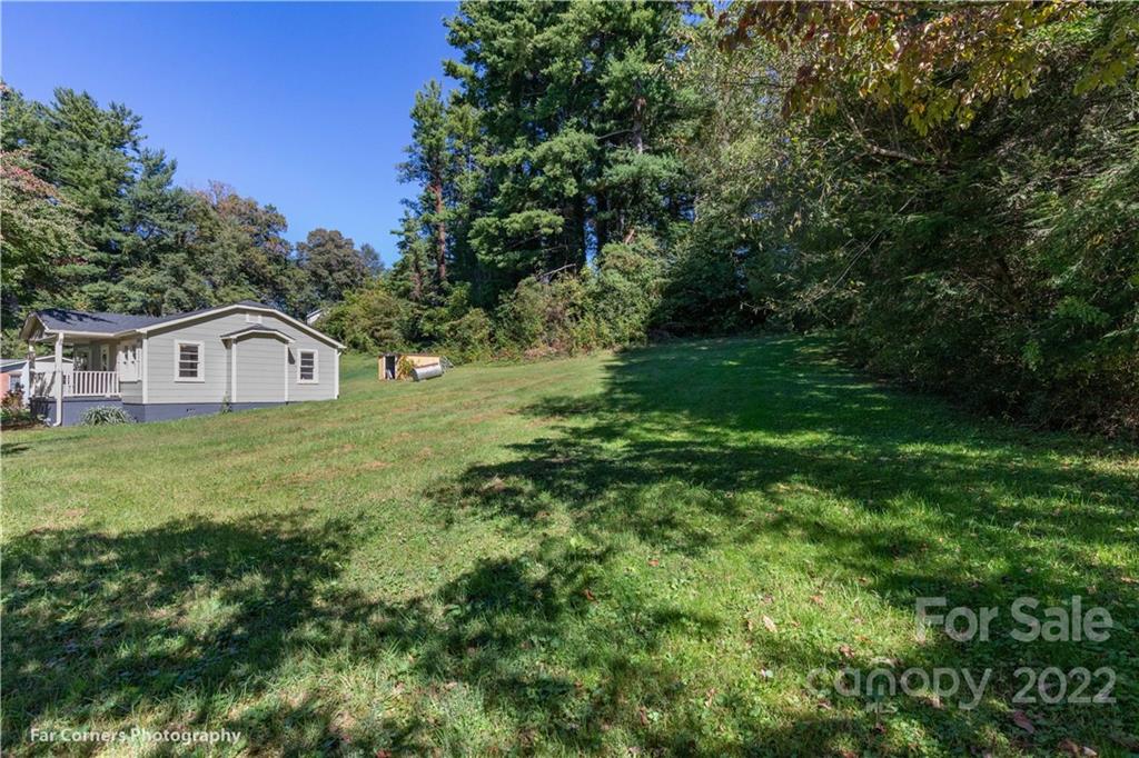 Tbd Duckett Cv Road Waynesville, NC 28786 - Photo 2 of 3 a house view with a garden