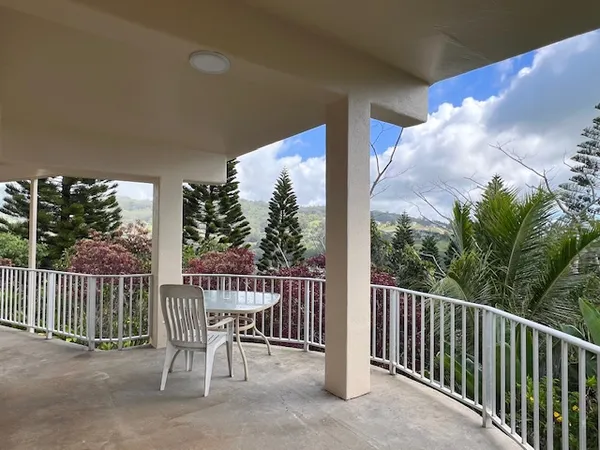a view of a chair and table in the balcony