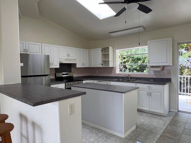 3320 B Wawae Road Kalaheo, HI 96741 - Photo 7 of 15 a kitchen with stainless steel appliances granite countertop a sink stove and refrigerator