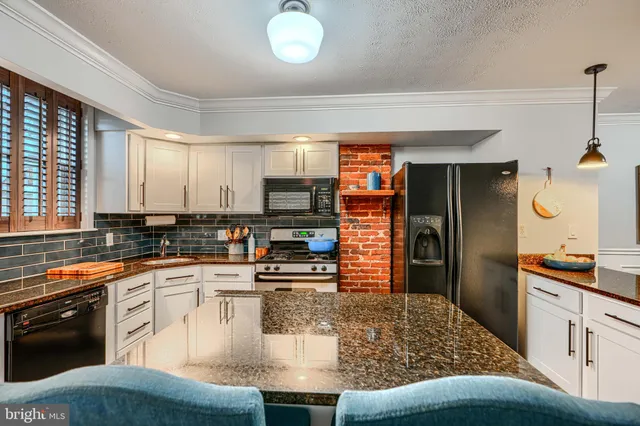 a kitchen with a stove and a sink