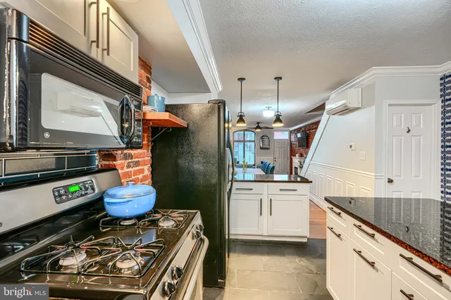 a living room with furniture a ceiling fan and a rug