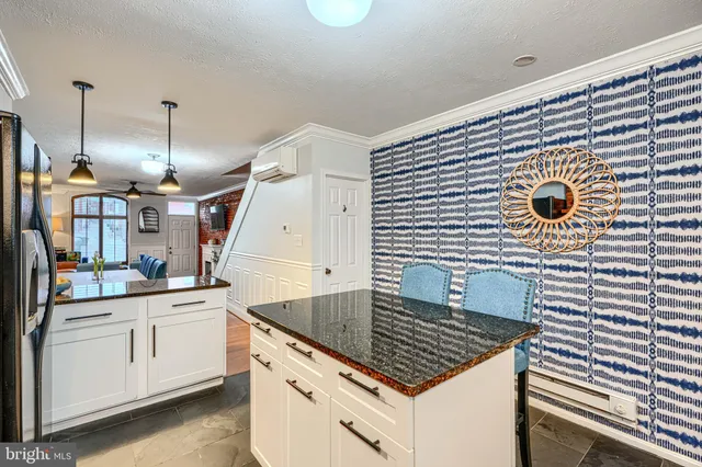 a bedroom with a bed a flat screen tv and a large dresser