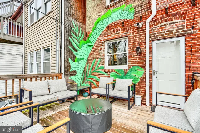 a bedroom with a bed a dresser and flat screen tv
