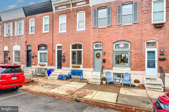 a living room with furniture wooden floor and a ceiling fan