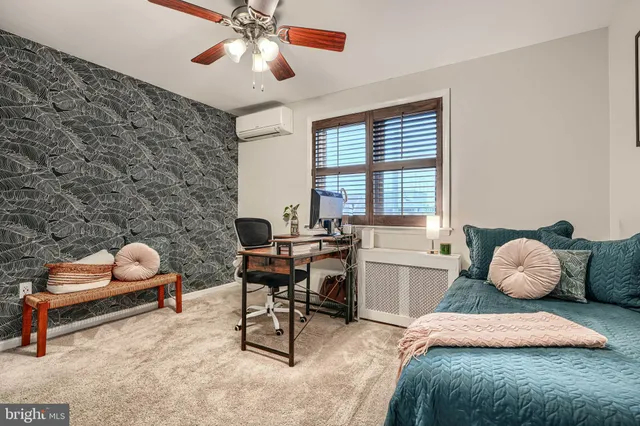 a view of a house with wooden stairs and a small yard