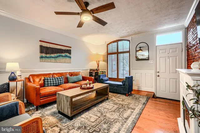 a view of a dining room with furniture a kitchen and chandelier