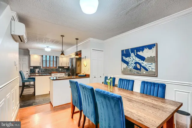 a kitchen with stainless steel appliances kitchen island granite countertop a refrigerator and a sink