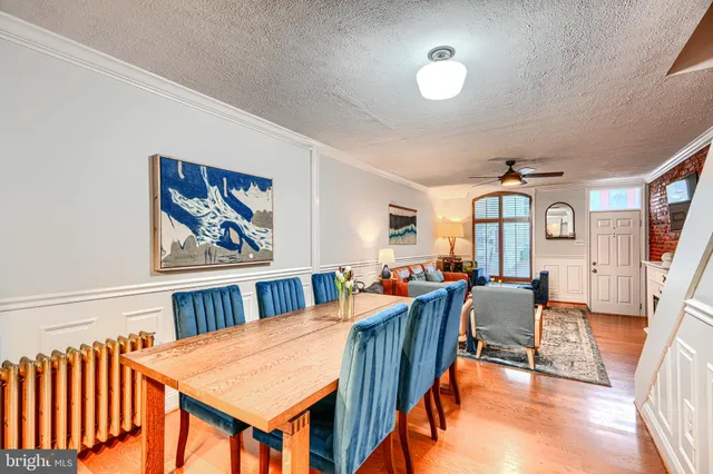 a kitchen with refrigerator and chairs