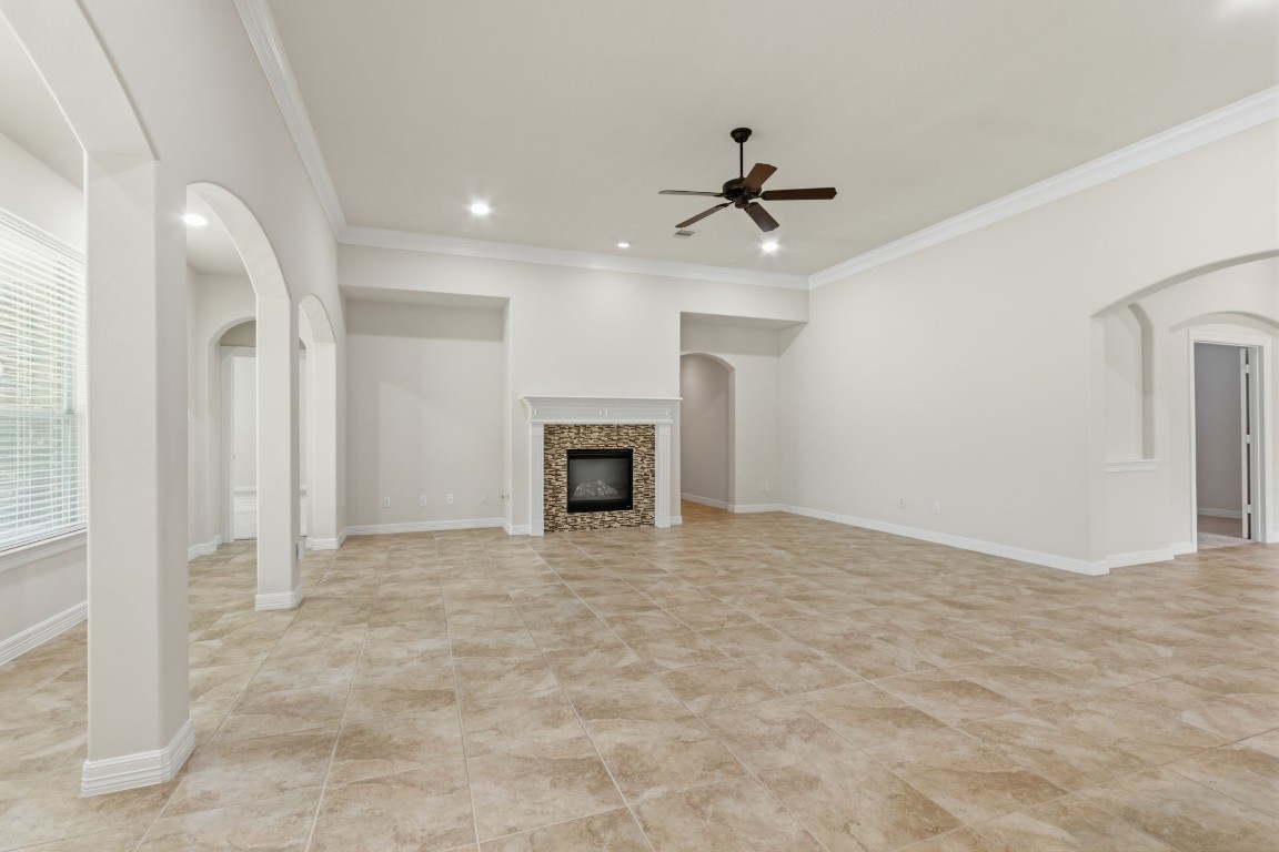 17711 Ravenno Lane Spring, TX 77379 - Photo 13 of 50 Spacious Family Room with high ceilings, gas log fireplace and a wall of windows overlooking the beautiful backyard