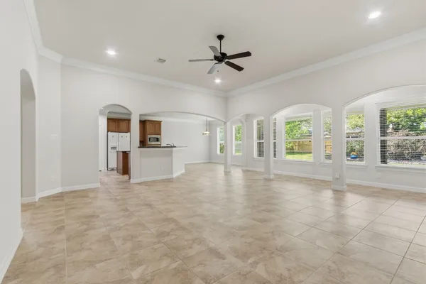 a large kitchen with granite countertop a sink and stainless steel appliances