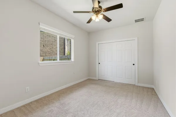 an aerial view of a house with yard and swimming pool