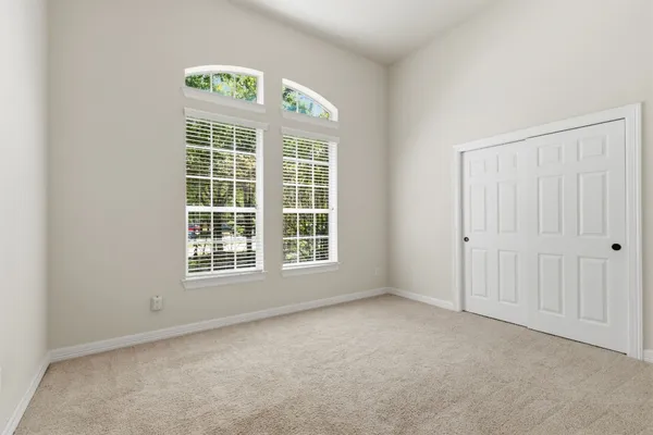 an aerial view of a house with a yard and trees