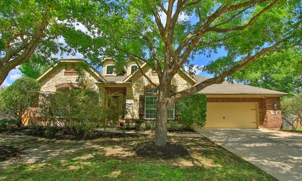 a view of a house with a tree in the background