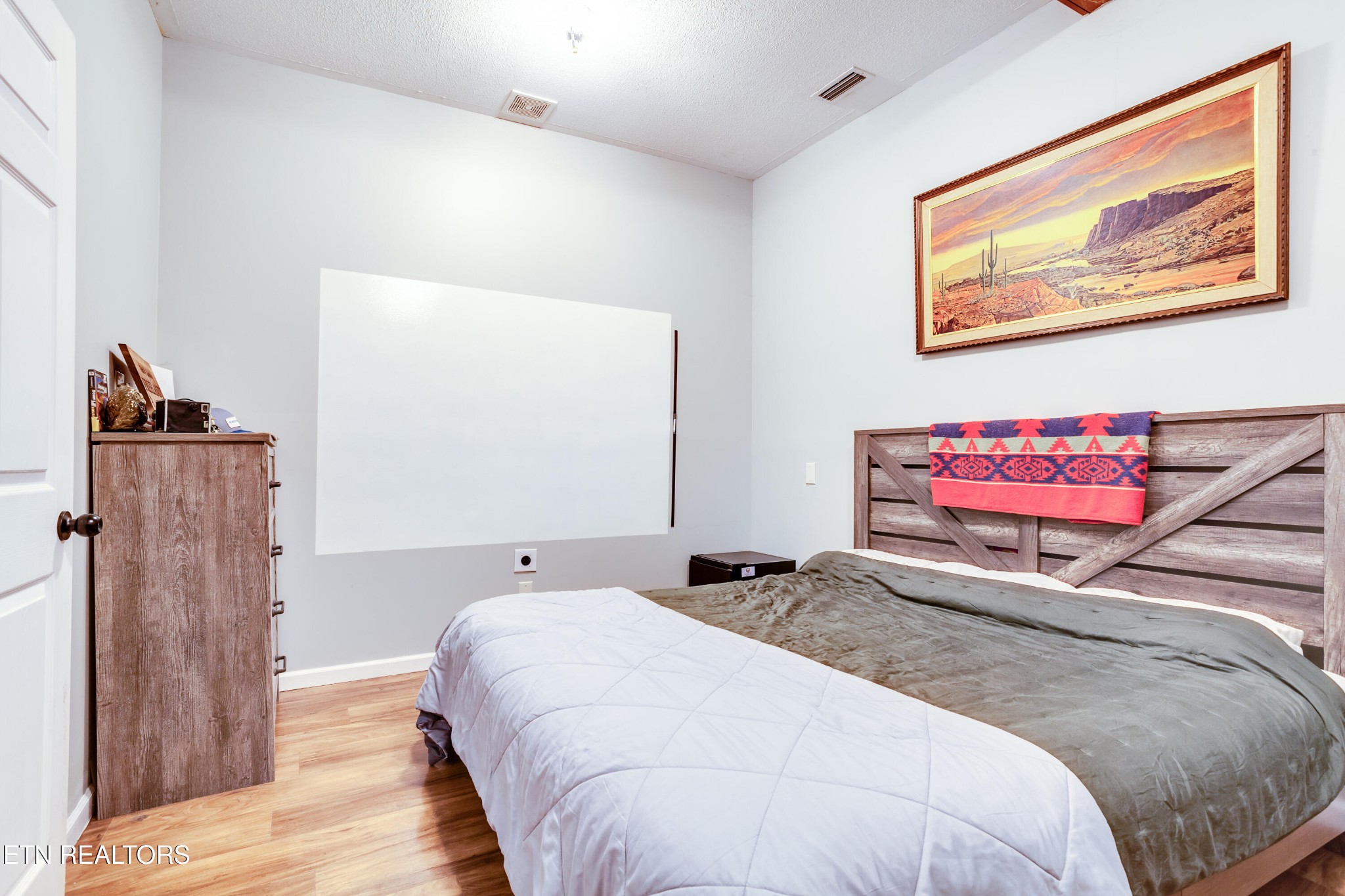 643 Airport Road Oakdale, TN 37829 - Photo 18 of 56 a bedroom with a bed and wooden floor