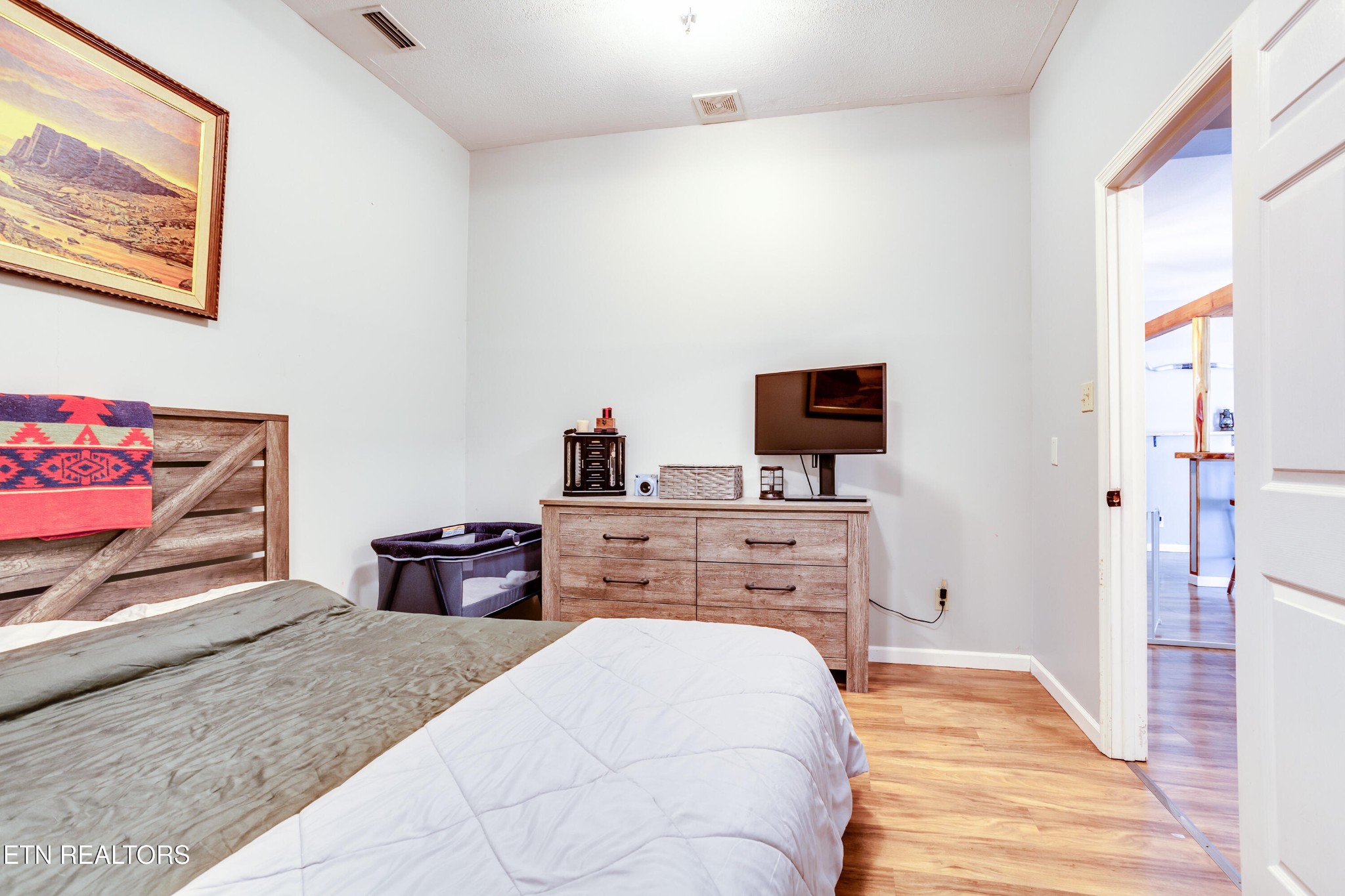 643 Airport Road Oakdale, TN 37829 - Photo 19 of 56 a bedroom with a bed and flat screen tv