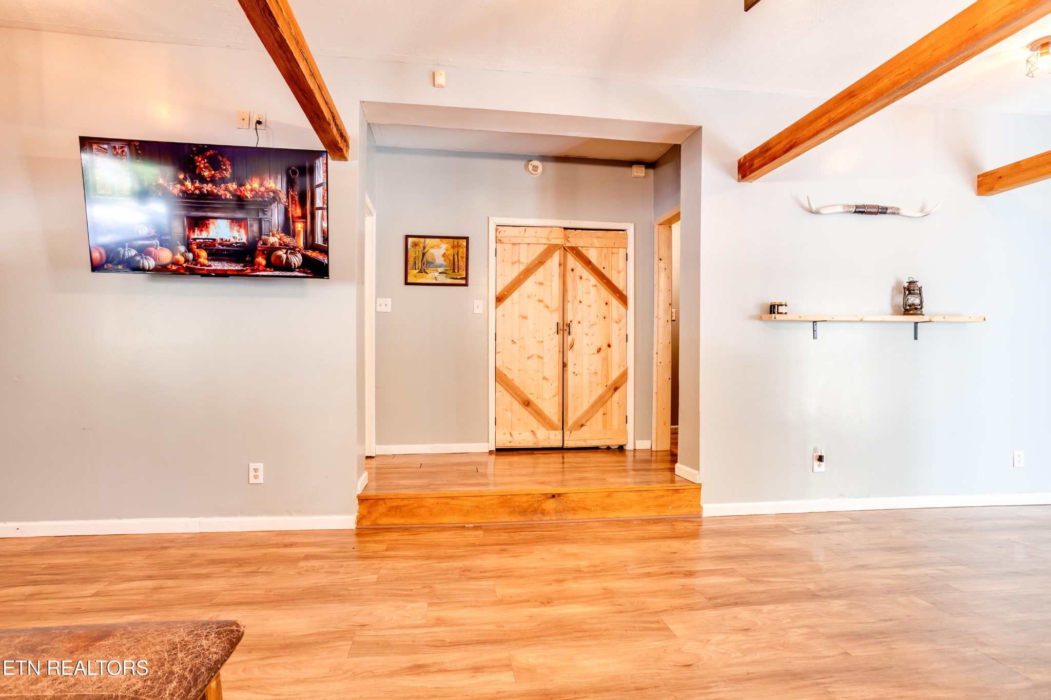 643 Airport Road Oakdale, TN 37829 - Photo 22 of 56 a view of a livingroom with an empty space and wooden floor