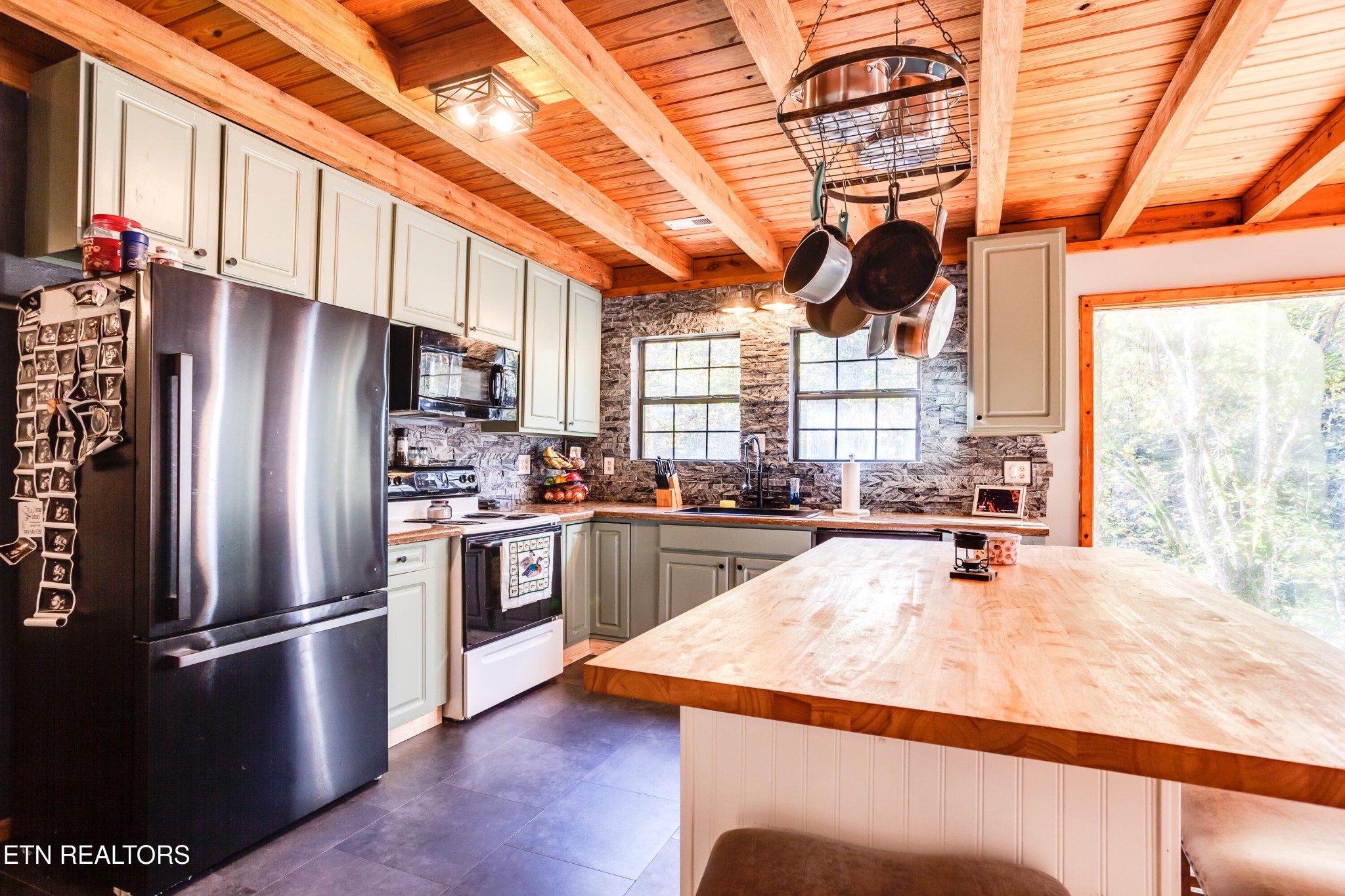 643 Airport Road Oakdale, TN 37829 - Photo 28 of 56 a kitchen with stainless steel appliances granite countertop a refrigerator a sink dishwasher a stove and white countertops with wooden floor