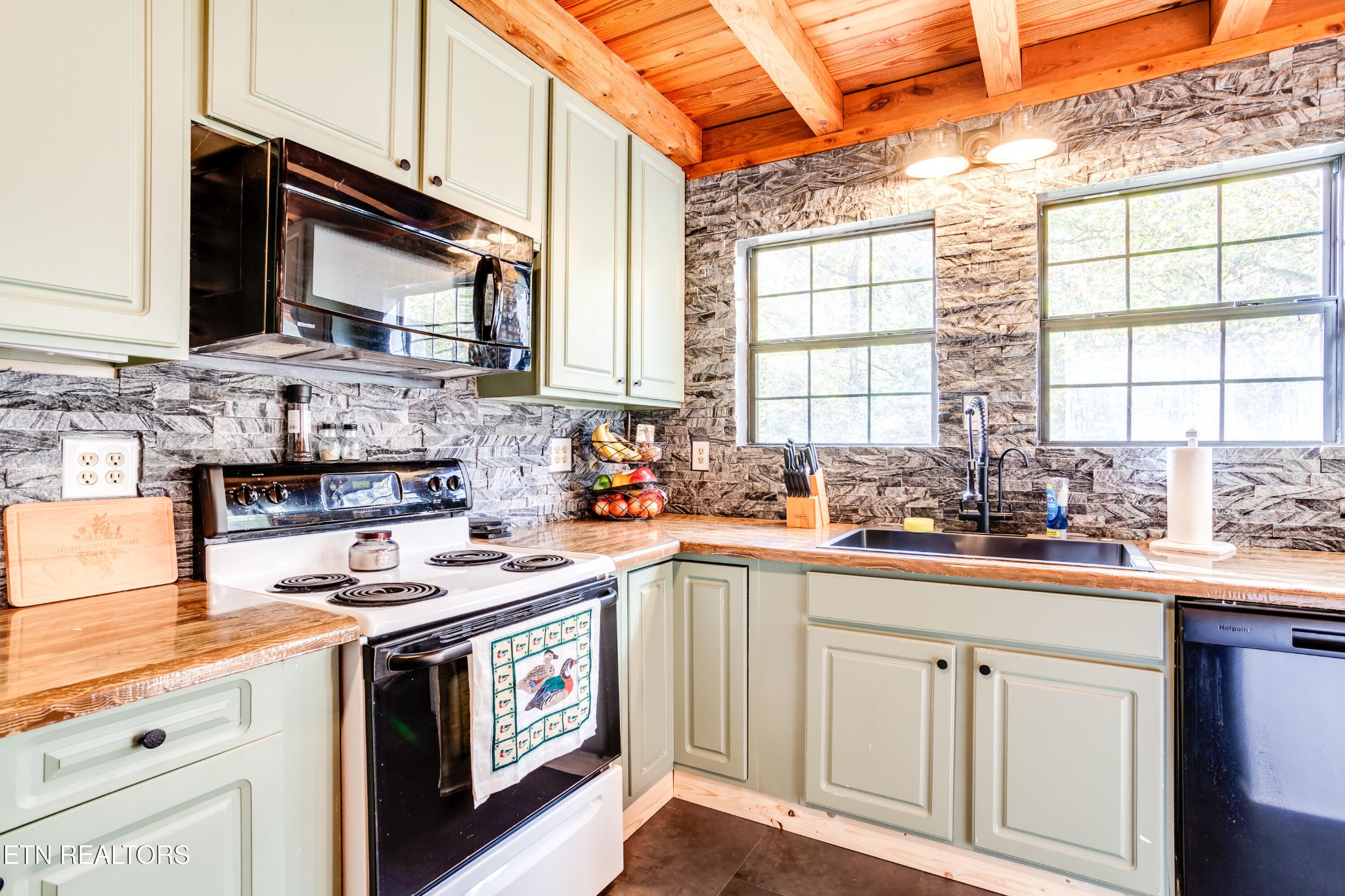 643 Airport Road Oakdale, TN 37829 - Photo 29 of 56 a kitchen with stainless steel appliances a sink stove and cabinets