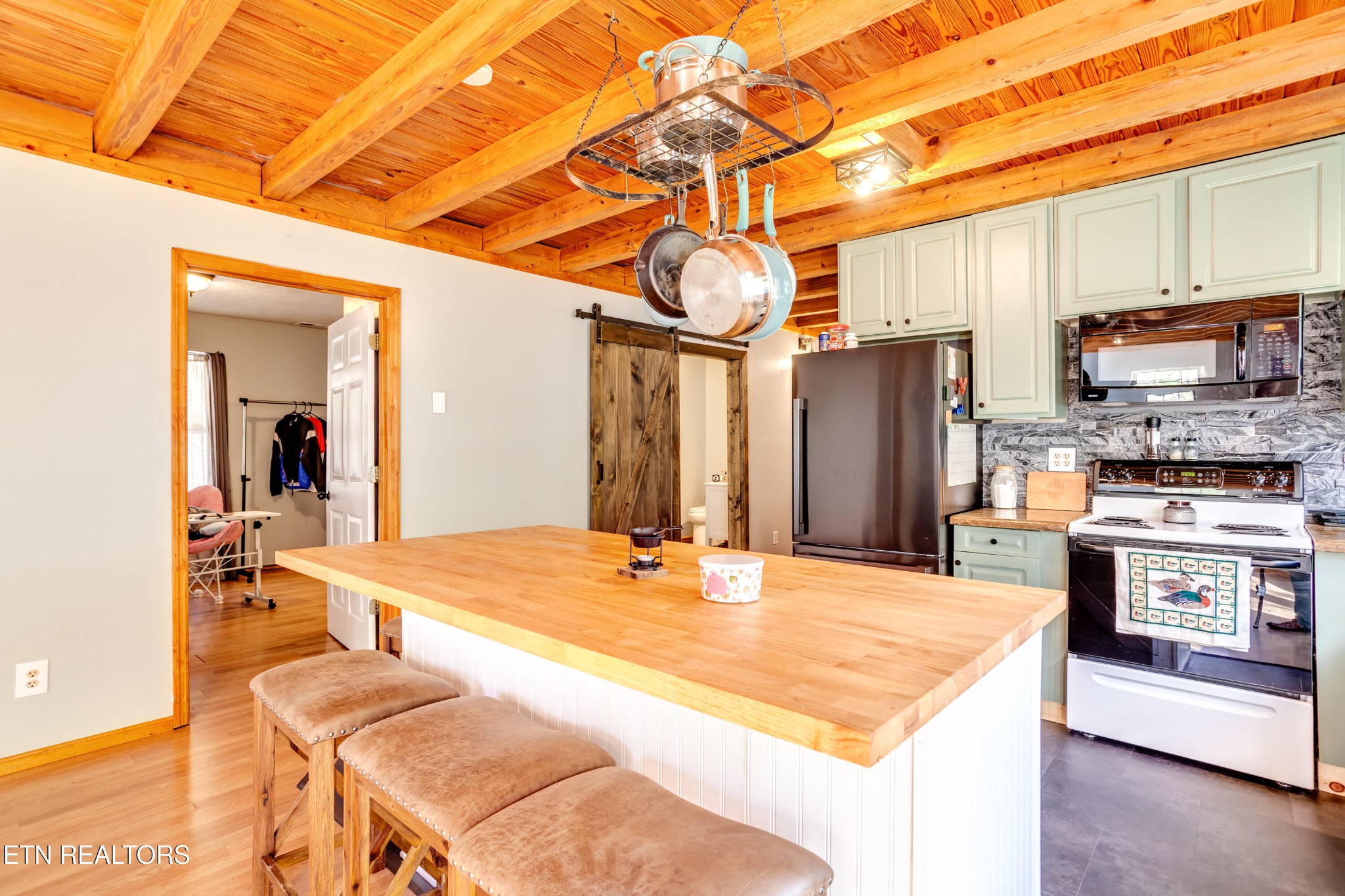 643 Airport Road Oakdale, TN 37829 - Photo 39 of 56 a room with stainless steel appliances kitchen island granite countertop a refrigerator a stove and a wooden cabinets