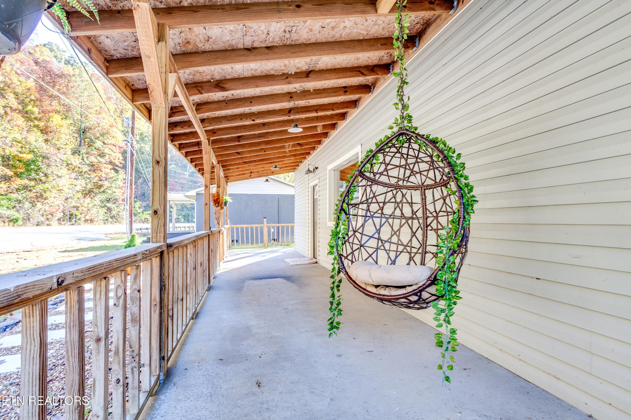 643 Airport Road Oakdale, TN 37829 - Photo 7 of 56 a view of a porch with a table and chairs