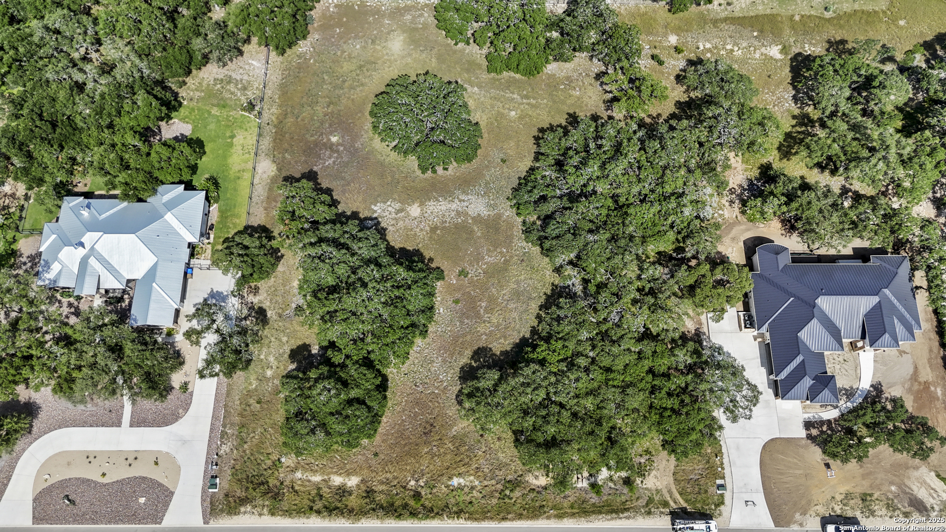 an aerial view of a house with a yard