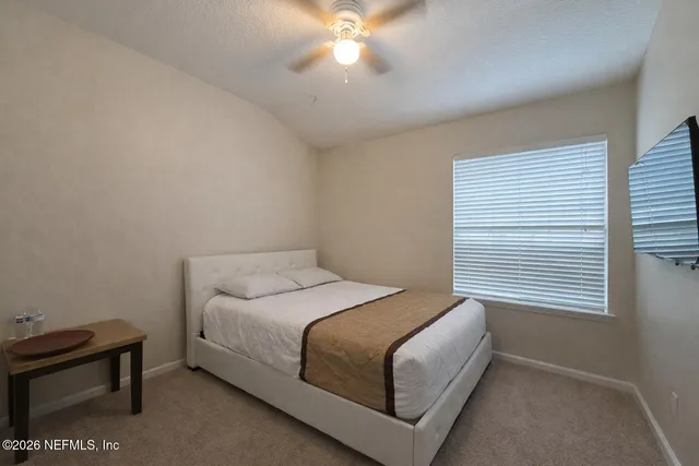 a bedroom with a bed and a window