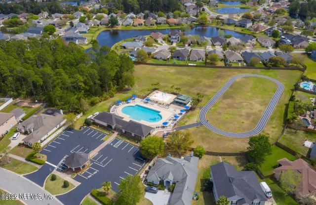 an aerial view of residential houses with outdoor space