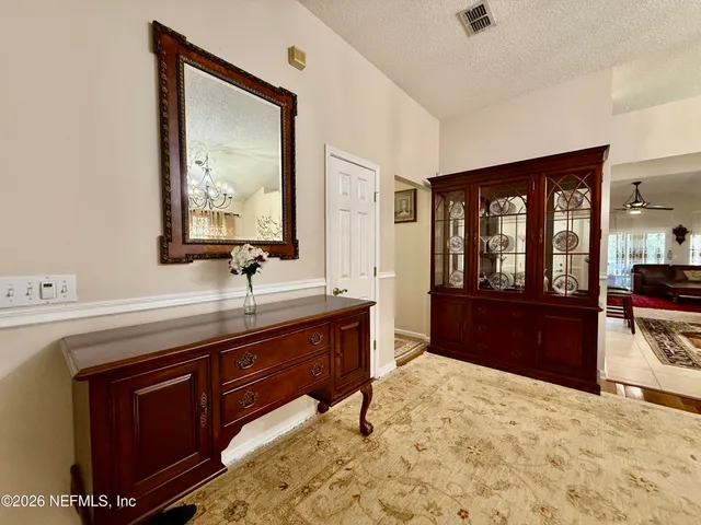a spacious bathroom with a tub sink and mirror