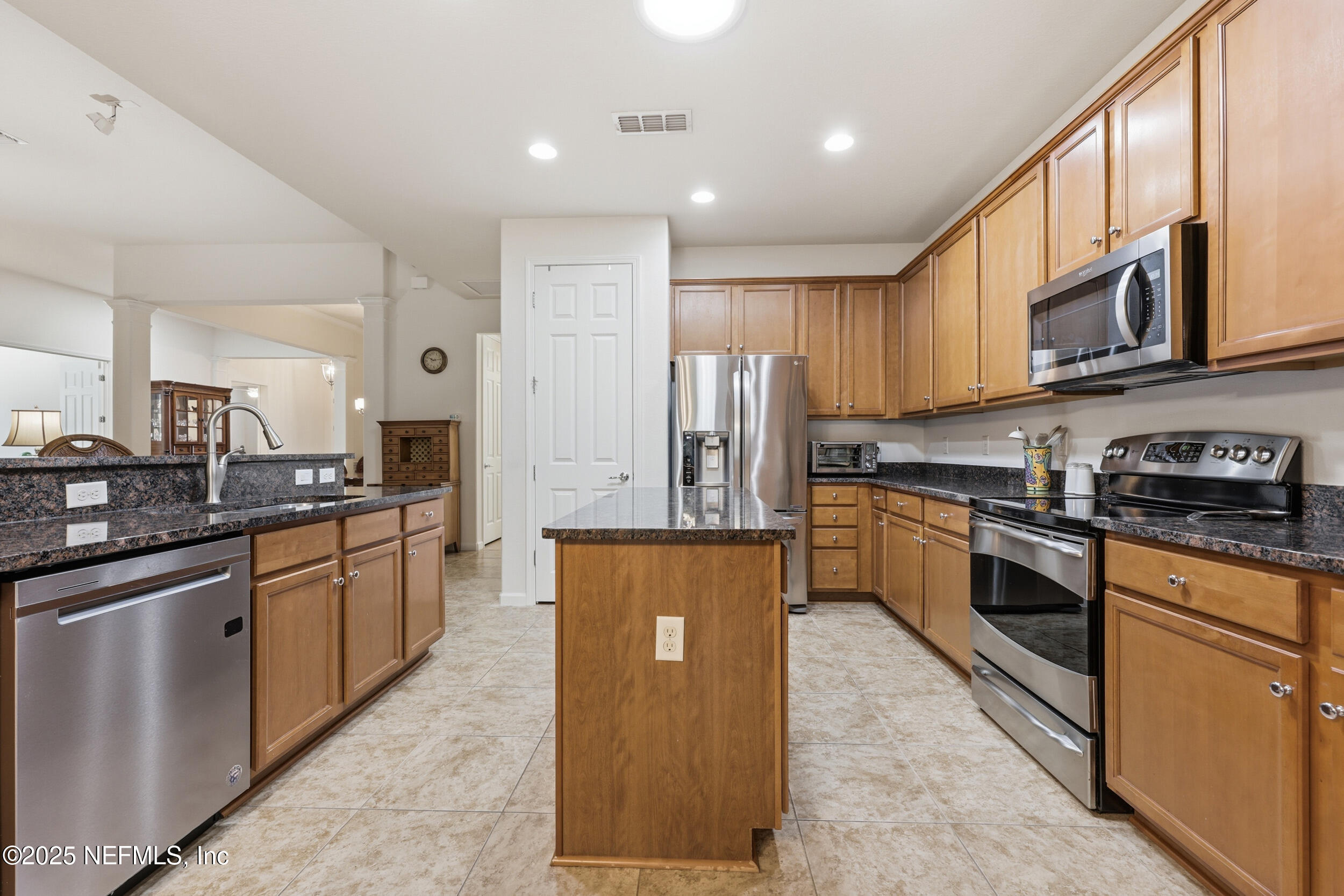 653 River Run Boulevard Ponte Vedra, FL 32081 - Photo 12 of 130 a kitchen with stainless steel appliances granite countertop a refrigerator a stove top oven a sink and dishwasher