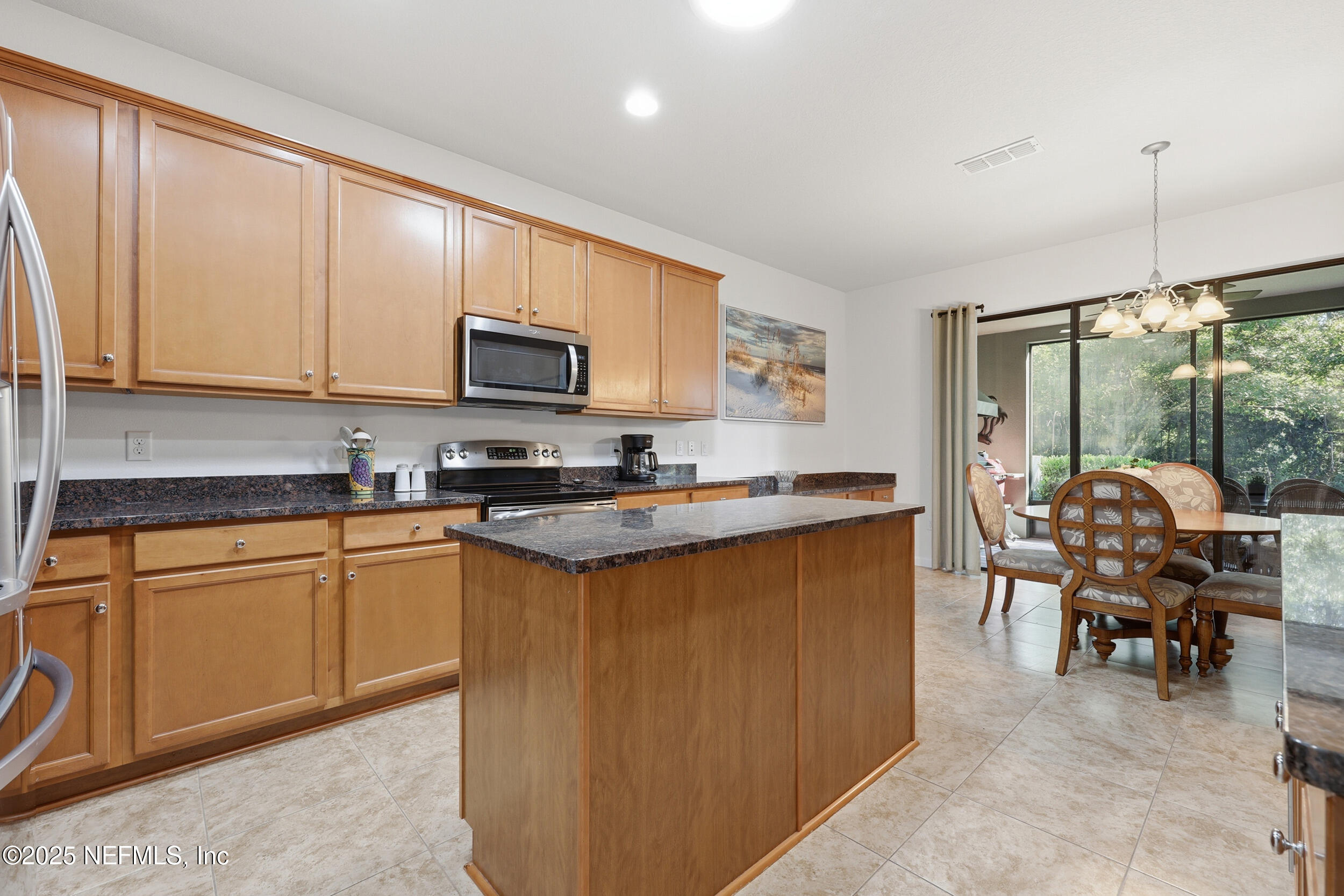 653 River Run Boulevard Ponte Vedra, FL 32081 - Photo 14 of 130 a kitchen with granite countertop a stove top oven sink dining table and chairs