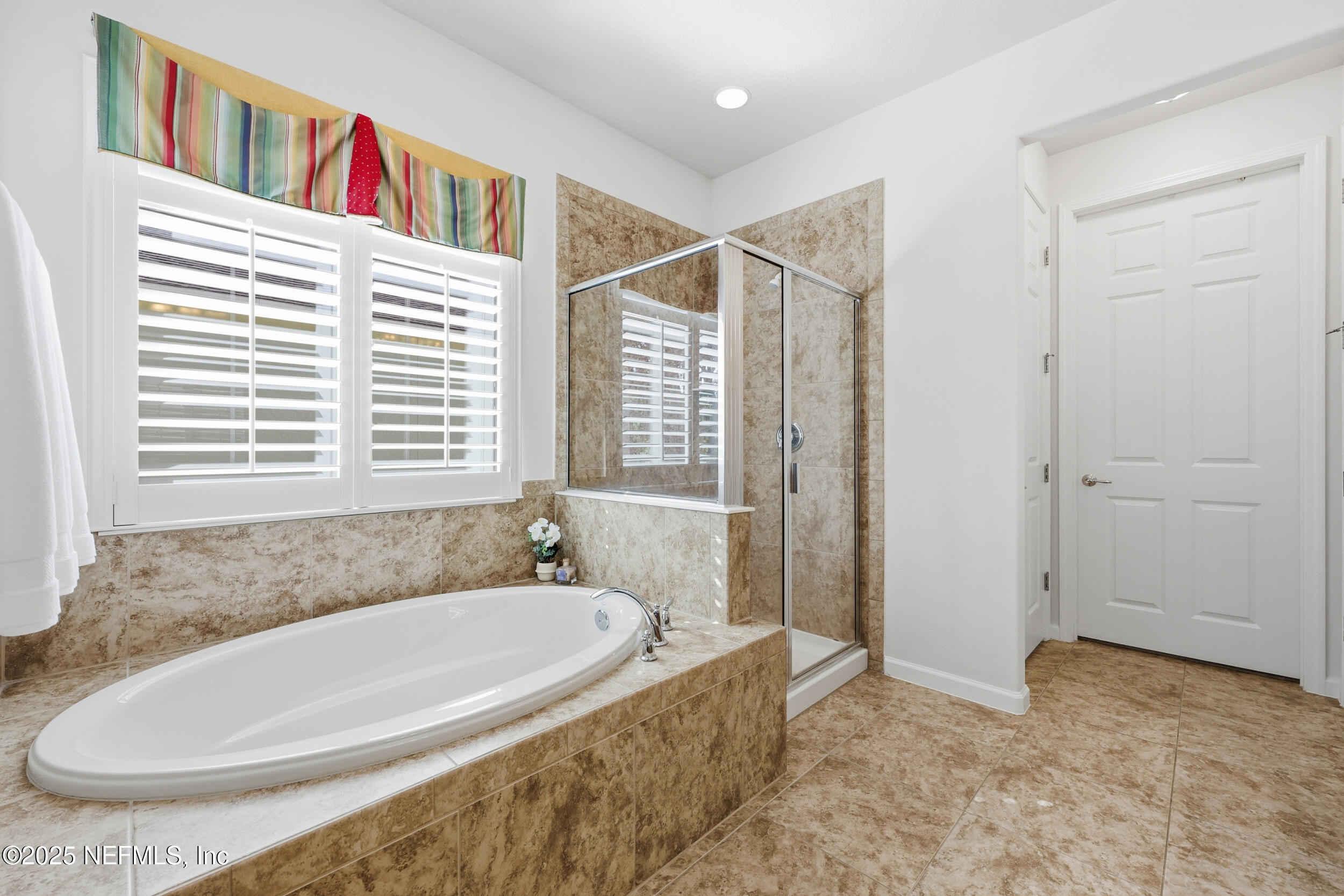 653 River Run Boulevard Ponte Vedra, FL 32081 - Photo 26 of 130 a bathroom with a bathtub and a window