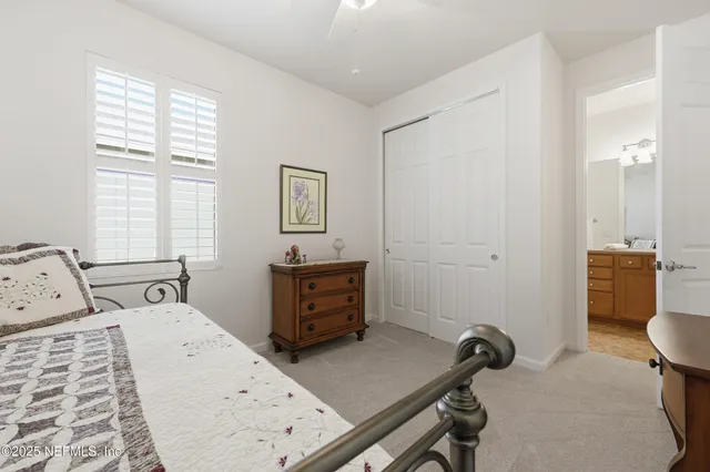 a living room with furniture a large window and wooden floor
