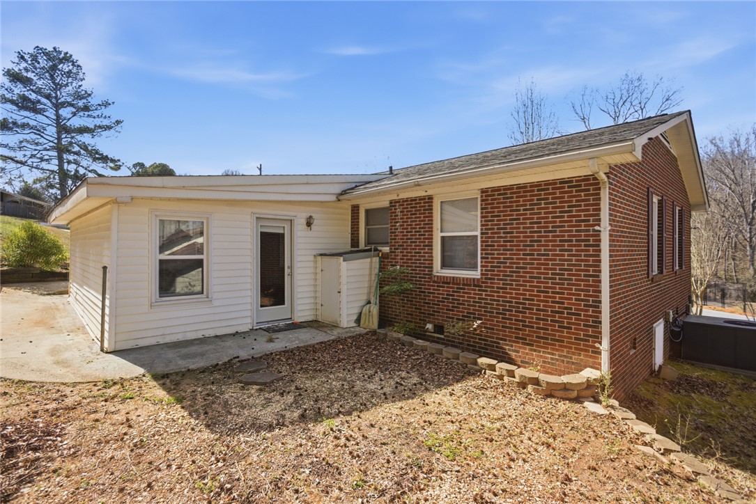 108 Hodge Street Abbeville, SC 29620 - Photo 24 of 39 A classic brick exterior meets a versatile addition, creating a dynamic residential facade.