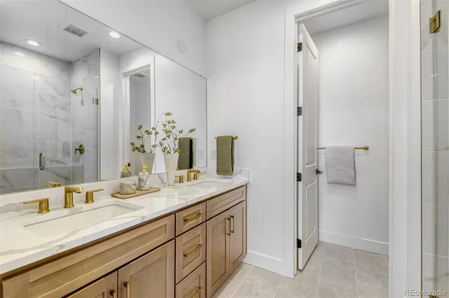 a spacious bathroom with a granite countertop sink mirror and double