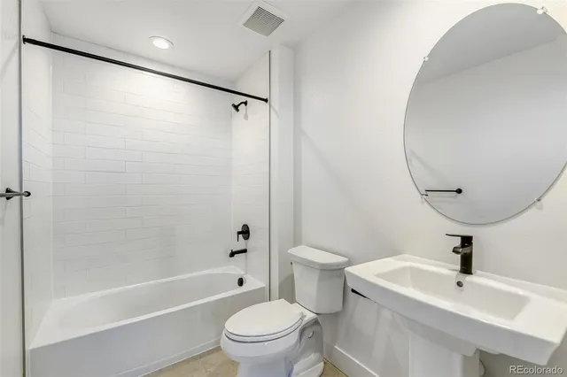a bathroom with a sink a toilet and a bathtub