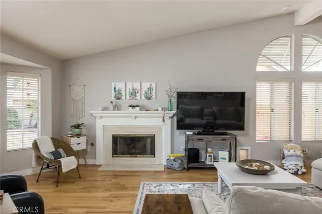 a living room with furniture a fireplace and a flat screen tv