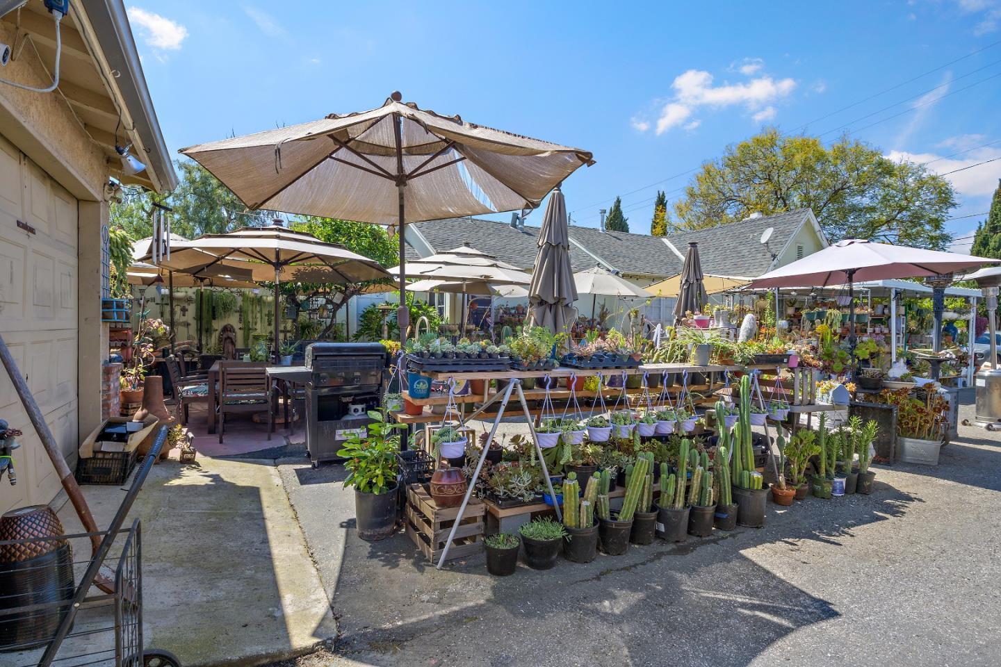 310 Lewis Road San Jose, CA 95111 - Photo 13 of 27 a view of a patio with chairs and table under an umbrella