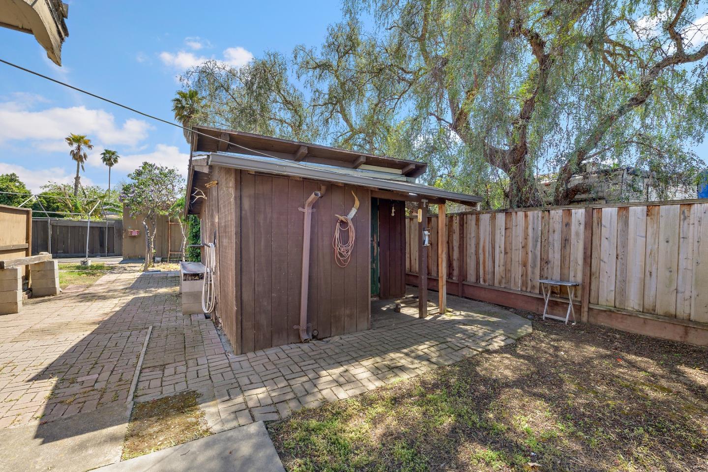 310 Lewis Road San Jose, CA 95111 - Photo 17 of 27 a backyard of a house with lawn chairs and wooden fence
